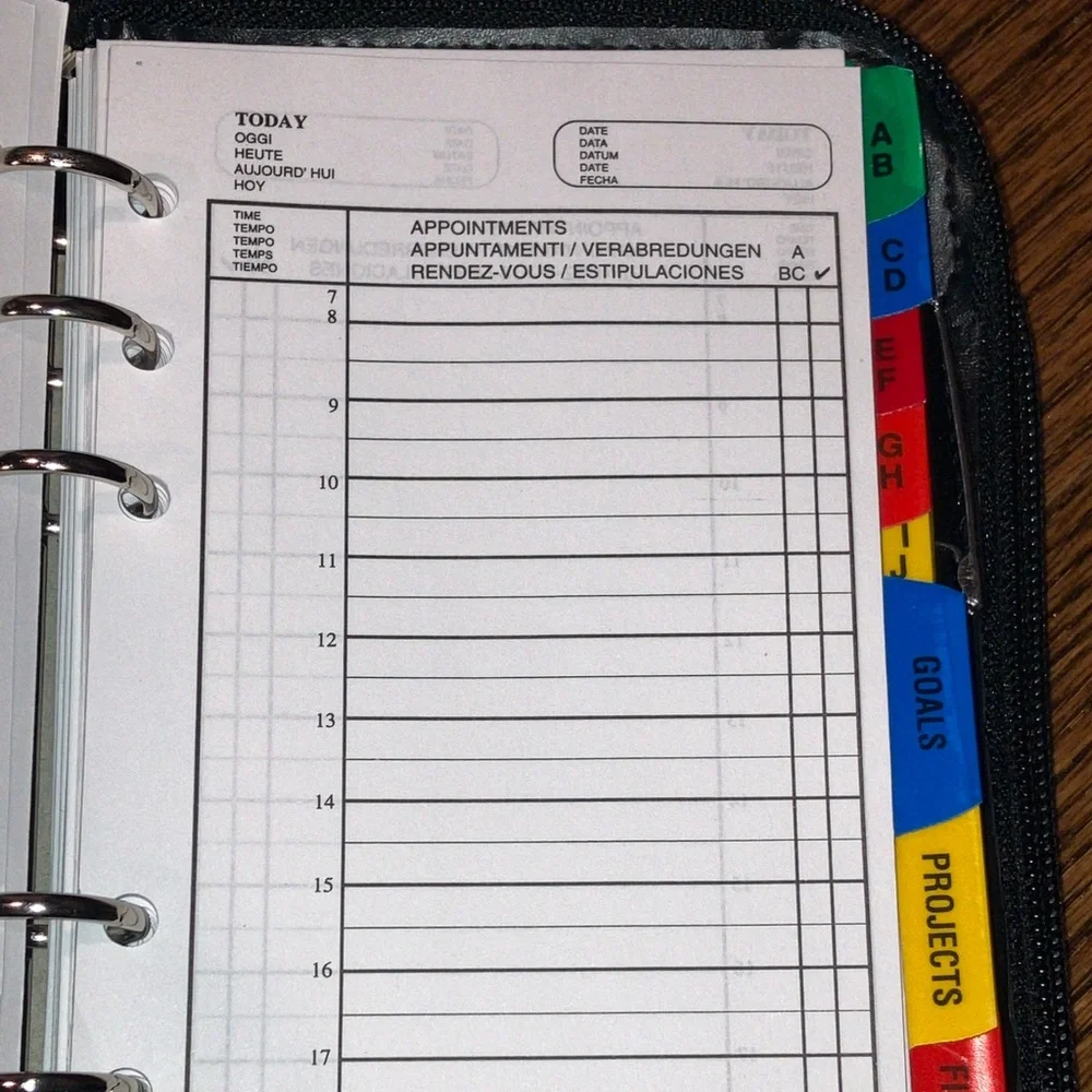 Black planner/organizer with zippered closure, wallet slot, addresses, goals